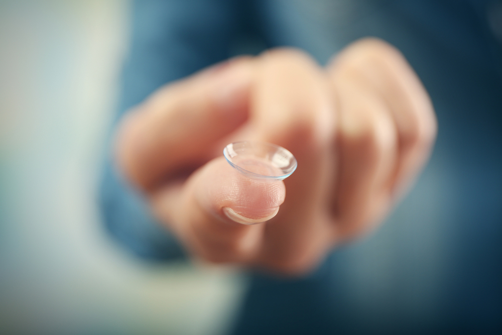 person holding a soft contact lens